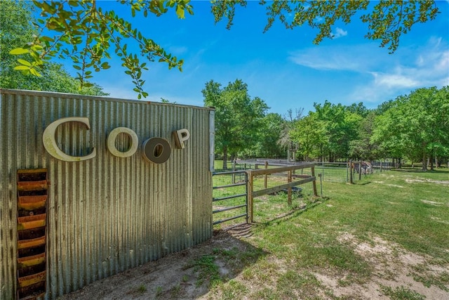 view of gate featuring a lawn and fence