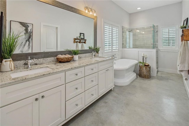 bathroom featuring double vanity, a freestanding tub, a tile shower, a sink, and concrete floors