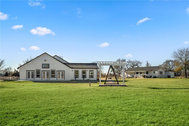 6191 Bethel Cemetery Rd, North Zulch, TX 77872 - back of property with french doors, a lawn, and a pergola