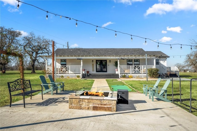 6191 Bethel Cemetery Rd, North Zulch, TX 77872 - view of front of home with an outdoor fire pit, a front yard, a shingled roof, and covered porch