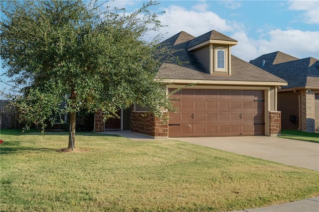 view of front of house with a front yard and a garage