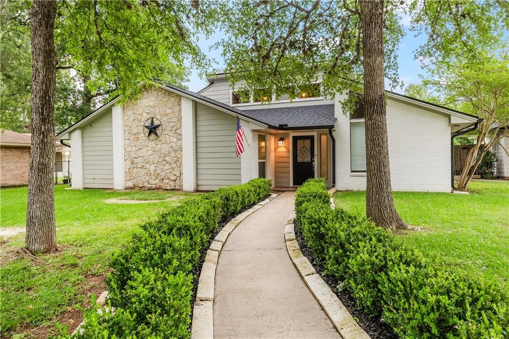 mid-century home with a front lawn
