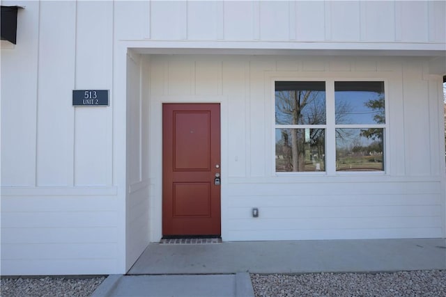 property entrance featuring board and batten siding