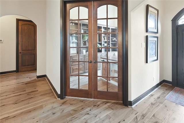 doorway featuring light wood-type flooring and french doors