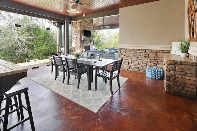 view of patio featuring ceiling fan and an outdoor stone fireplace