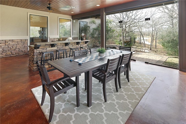 sunroom / solarium featuring ceiling fan and wood ceiling