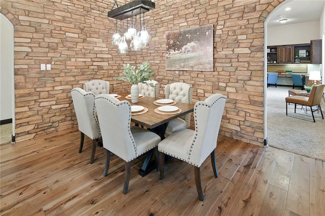 dining area with a notable chandelier and light wood-type flooring