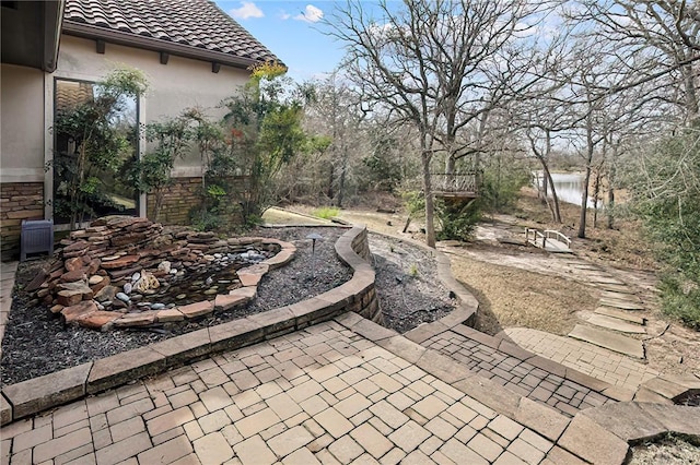 view of patio with a water view