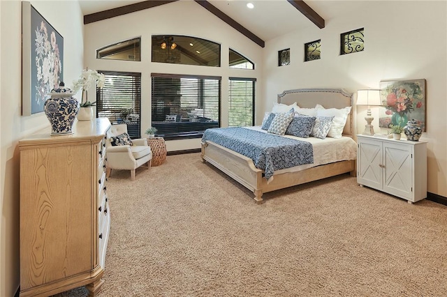 bedroom featuring ceiling fan, light colored carpet, and lofted ceiling with beams