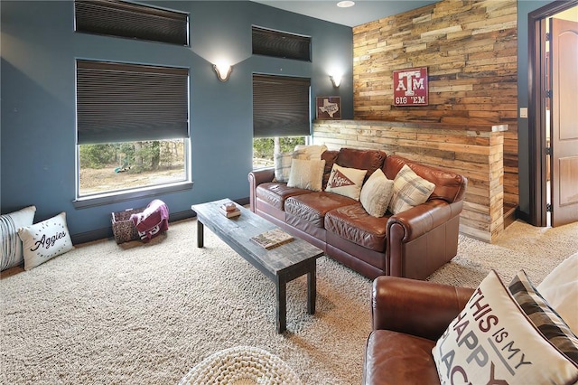 carpeted living room featuring wooden walls