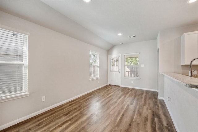 interior space with vaulted ceiling and hardwood / wood-style flooring