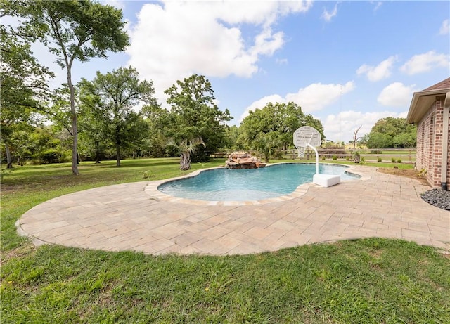 outdoor pool with a lawn and a patio