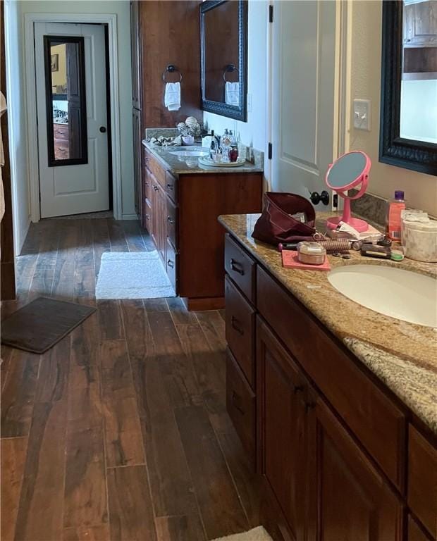 bathroom with a sink and wood finished floors