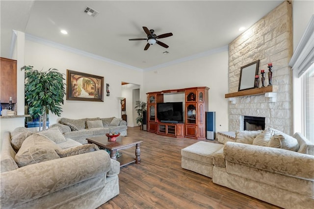 living area featuring dark wood-style flooring, a fireplace, crown molding, and visible vents