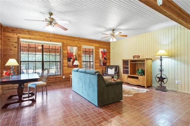 living room with wooden walls and ceiling fan