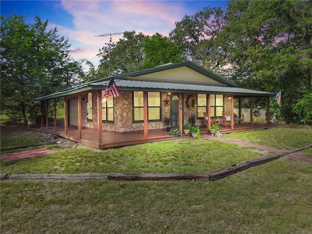 back house at dusk with a yard