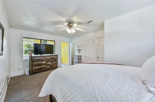 bedroom featuring carpet flooring, a textured ceiling, and ceiling fan