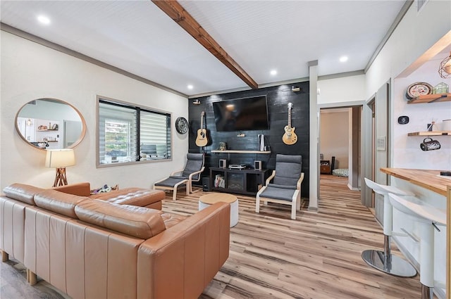 living room featuring beamed ceiling, light wood-type flooring, and crown molding