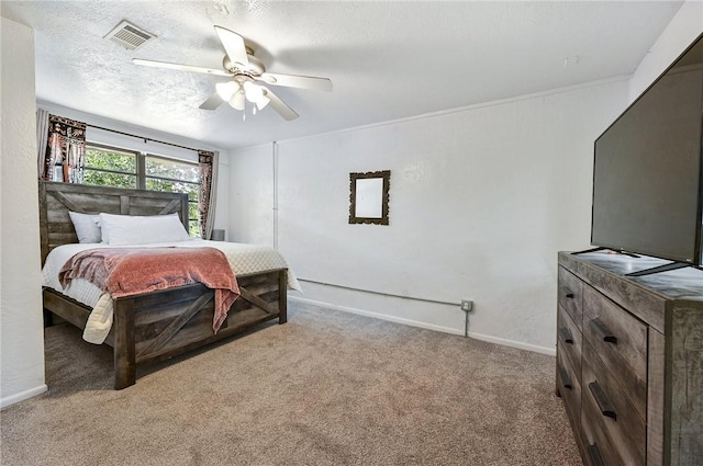 carpeted bedroom featuring a textured ceiling and ceiling fan