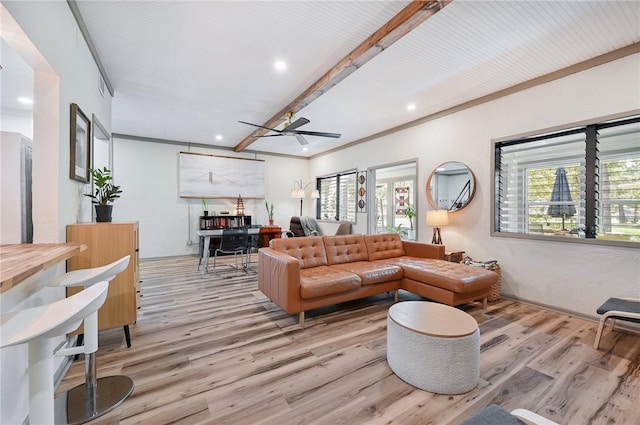 living room featuring ceiling fan, crown molding, and light wood-type flooring