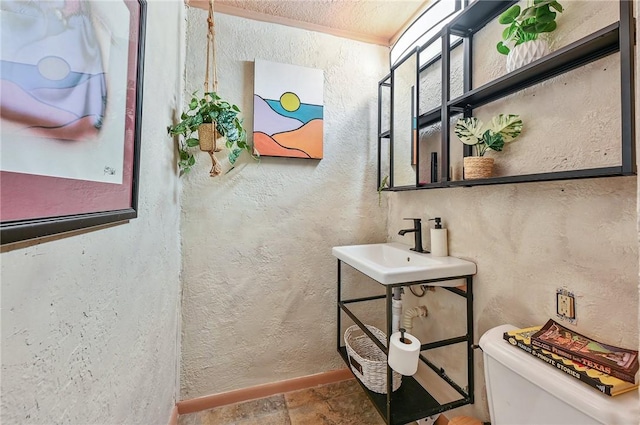 bathroom featuring sink and toilet