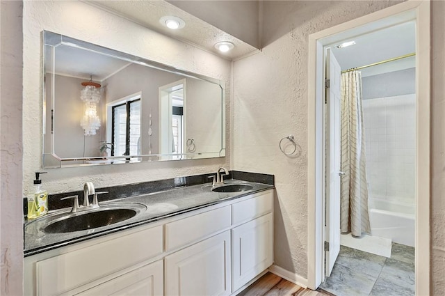 bathroom featuring shower / bath combination with curtain, vanity, and hardwood / wood-style floors