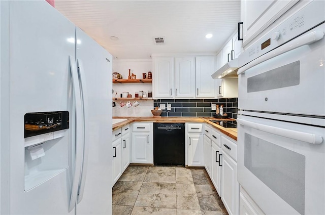 kitchen with decorative backsplash, black appliances, white cabinets, butcher block countertops, and range hood