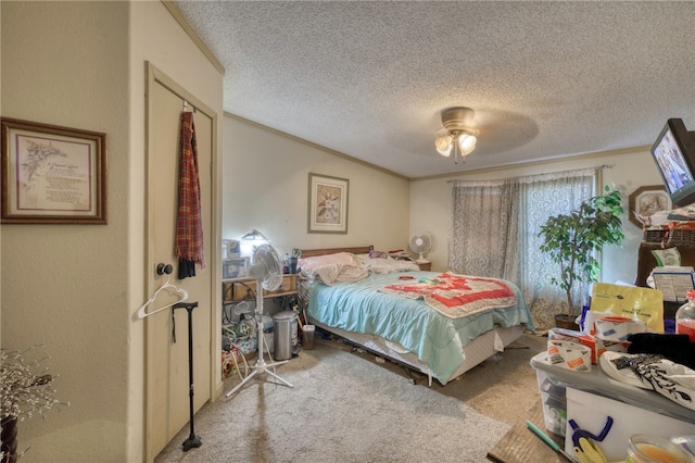 bedroom with ornamental molding, carpet, ceiling fan, and a textured ceiling