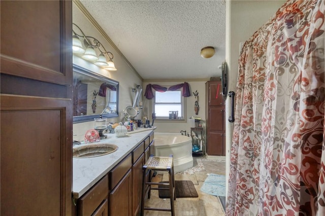 bathroom featuring ornamental molding, vanity, and a textured ceiling