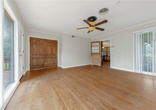 107 E N Ave, Bryan, TX 77801 - unfurnished room featuring a ceiling fan, light wood-style flooring, crown molding, and baseboards