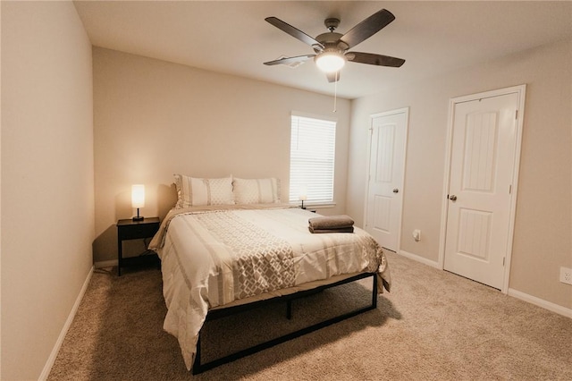 carpeted bedroom featuring baseboards and a ceiling fan