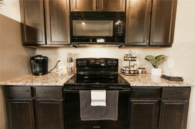 kitchen featuring dark brown cabinetry, black appliances, and light stone countertops