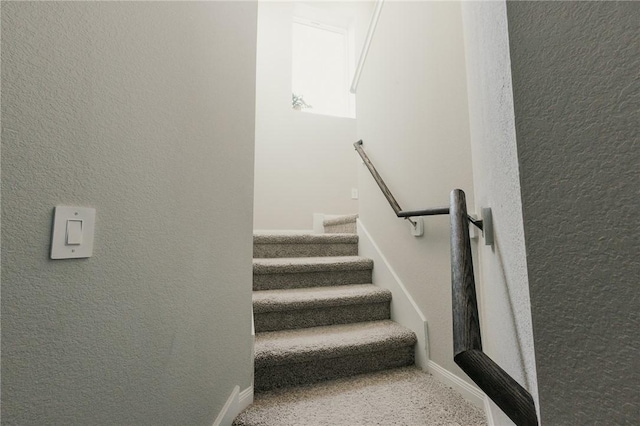 stairs featuring a textured wall