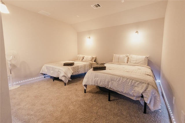 bedroom featuring visible vents, lofted ceiling, and carpet