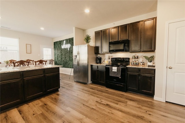 kitchen featuring recessed lighting, visible vents, light wood-style floors, and black appliances