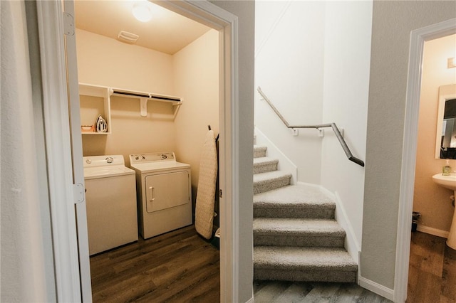 washroom featuring laundry area, independent washer and dryer, baseboards, and dark wood-style flooring