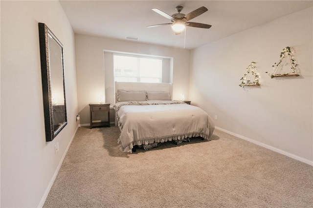 carpeted bedroom featuring visible vents, baseboards, and a ceiling fan