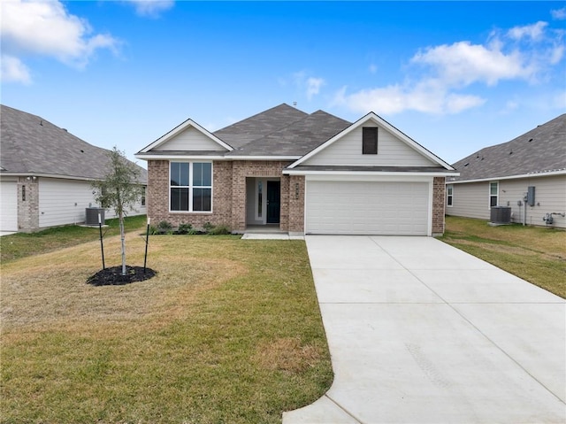 view of front of property featuring central AC, a front yard, and a garage