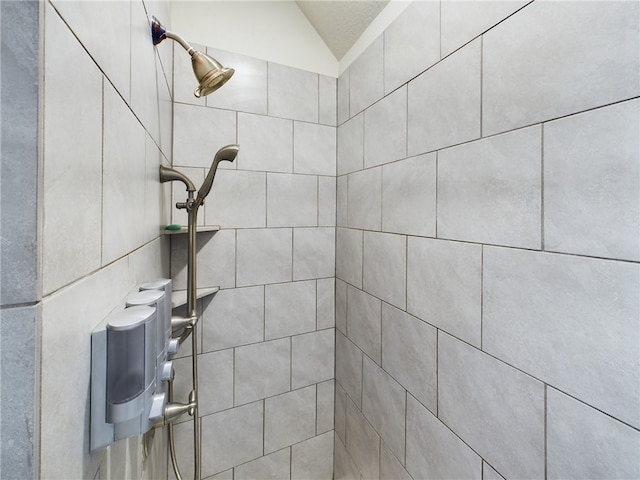 interior details featuring tiled shower