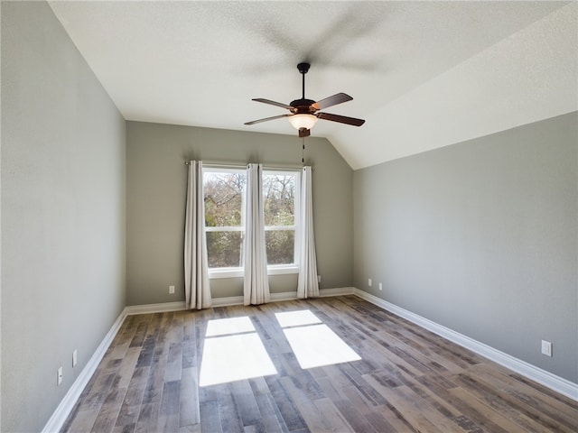 spare room with baseboards, a textured ceiling, a ceiling fan, and wood finished floors