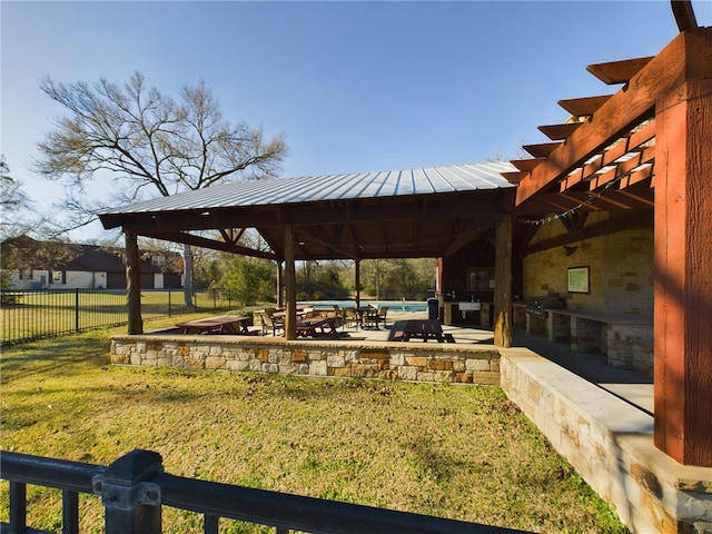 view of property's community with a patio, fence, a gazebo, and a lawn