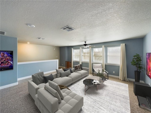 living room featuring visible vents, light carpet, and baseboards