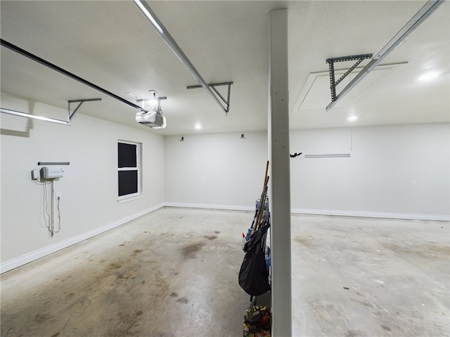 garage with baseboards and a garage door opener