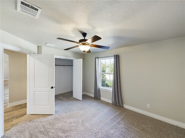 unfurnished bedroom featuring baseboards, visible vents, a ceiling fan, a textured ceiling, and a closet