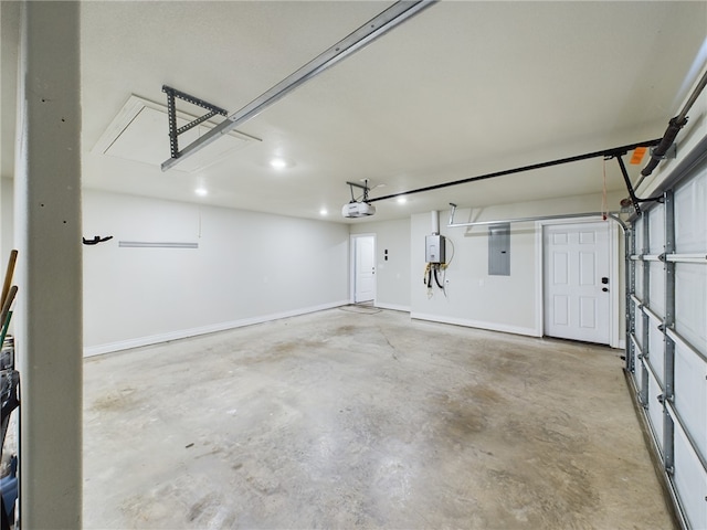 garage with a garage door opener, electric panel, and baseboards