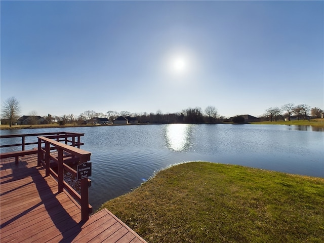 view of dock featuring a yard and a water view