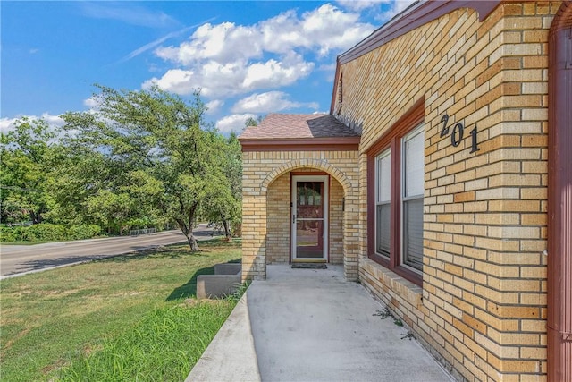 doorway to property with a yard