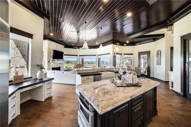 2289 Old Dobbin Rd, Montgomery, TX 77316 - kitchen featuring a spacious island, open floor plan, dark wood-style floors, light stone countertops, and wood ceiling