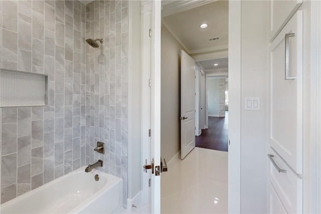 bathroom with hardwood / wood-style flooring, tiled shower / bath combo, and crown molding