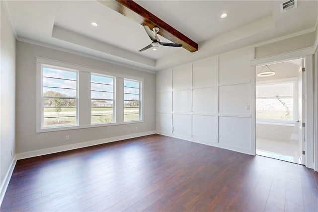 spare room with beamed ceiling, a raised ceiling, ceiling fan, and dark wood-type flooring